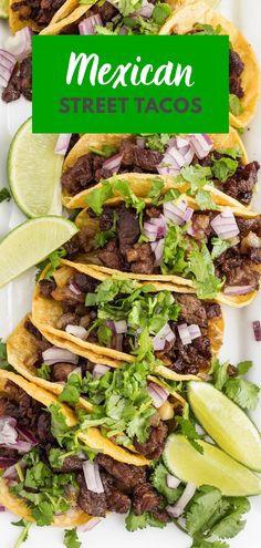 mexican street tacos on a white plate with lime wedges and cilantro