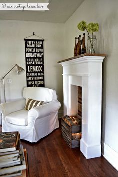 a living room filled with furniture and a fire place next to a white fireplace mantel