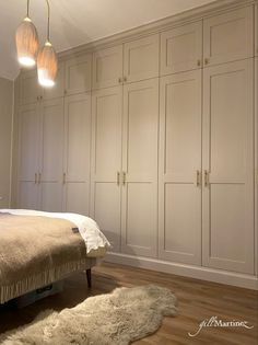 a large white bed sitting in a bedroom next to two lamps on top of it