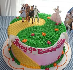 a birthday cake with toy figures on top