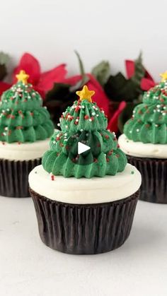 three cupcakes decorated with green frosting and christmas trees