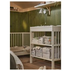 a baby crib in a room with green walls