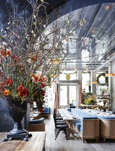 the dining room is decorated with flowers and greenery for an elegant touch to the space