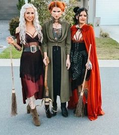 three women dressed up as witches standing next to each other