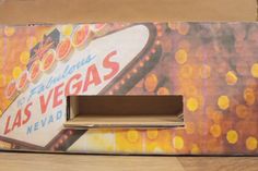 a cardboard box with a las vegas sign painted on it's front and side