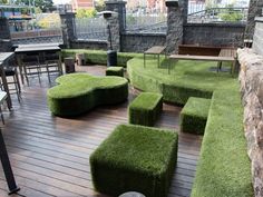 an outdoor seating area with grass on the ground