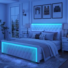 a bed with blue lights on the headboard and foot board, in a bedroom