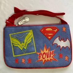 a small purse with superman and wonder symbols on it