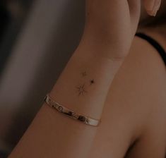 a woman's arm with a star tattoo on it