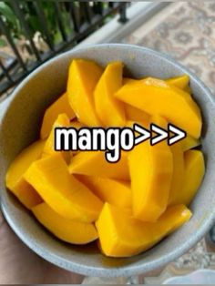 mangoes in a bowl with the word mango on it and an arrow pointing to them