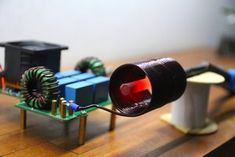 an electronic device that is on top of a wooden table with wires attached to it