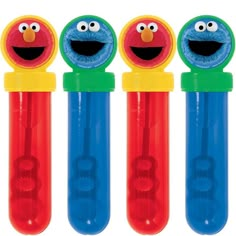 three plastic toothbrushes with sesame characters on them, one is blue and the other is red