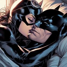 the batman and catwoman are cuddling together in bed, with each other's eyes closed