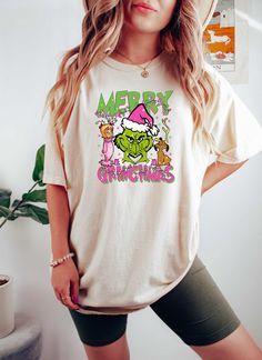 Merry Grinchmas Shirt, Grinch Cindy Lou and Max, Grinch Christmas Coquette Shirt, Comfort Colors, Dog Lover, Christmas Gifts, Grinch Shirt UNISEX Comfort Colors® Brand T-Shirt. -----How To Order----- 1-) Please, check and review all photos. 2-) Choose your t-shirt size and color. 3-) Click add to cart. You can go back to add more product. 4-)Click "Proceed to check out". 5-)When you check out, you can add a note to seller for any request. ---------- Product ---------- * 6.1 oz./yd² (US), 10 oz/L yd (CA), 100% ring spun cotton, 30 singles. * Garment dyed for that lived in feel and almost no shrinkage at home. * Soft ring spun cotton fabric with 100% cotton threads. * Relaxed fit. * Topstitched, classic width, rib collar. * Shoulder to shoulder twill tape. * Signature twill label. * Made Wit Merry Grinchmas Shirt, Grinch Cindy Lou, Funny Grinch, Grinch Shirt, Green Xmas, Grinch Shirts, Christmas Coquette, Merry Grinchmas, Christmas Party Shirts