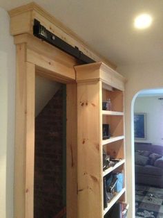 an open bookcase in the corner of a living room