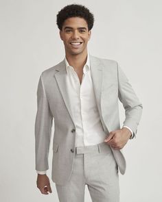 A modern twist on the classic grey suit thanks to its light colouration, you can't go wrong with this blazer for a flattering way to complete your outfit. Matching suit pants and jogger pants available.  - Slim fit for a close-to-the-body silhouette - Stretch fabric blend - Notch collar - Two-button closure - Chest pocket and flap pockets - Inner pockets - Back vent - Lined - Sleeve length: 35'' from center back (size 40) - Body length: 28.75" from center back (size 40) Light Grey Suit Men Wedding Party, Light Colour Blazers For Men, Light Gray Suits For Men, Gray Suits For Men, Mens Suits Wedding Guest, Light Gray Suit, Light Grey Suit Men Wedding, Light Grey Suit, Grey Wedding Suit