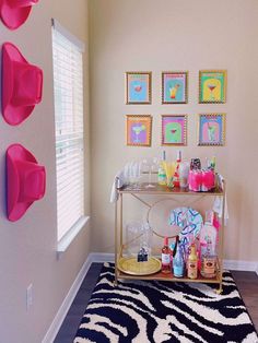 a living room with pictures on the wall and a zebra rug in front of it