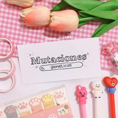 there is a pink and white checkered table cloth with some items on it, including scissors