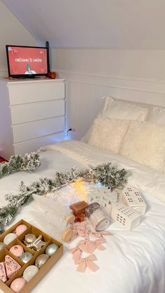 a white bed topped with lots of christmas decorations