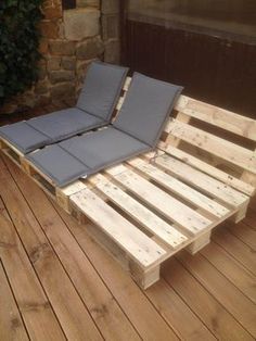 a bed made out of wooden pallets on a deck