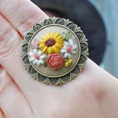 "This sunflower ring with an antique bronze setting makes such a statement! This sunflower ring has a gorgeous victorian feel. The antique bronze filigree band is adjustable to fit many finger sizes. This cameo sunflower ring makes an adorable addition to any outfit! The ring measures a total of 1-1/2\" across. The Embroidered sunflower on a tan cotton background measures 1\" in diameter. This ring was hand embroidered in Benton Arkansas! My packaging is cute and ready to gift! (See listing phot Vintage Handmade Flower Ring, Vintage Brown Flower-shaped Jewelry, Vintage Adjustable Sunflower Design Jewelry, Sunflower Ring, Embroidered Necklace, Nature Ring, Chunky Rings, Antique Bronze, Rings Statement