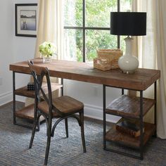 a wooden desk sitting next to a window