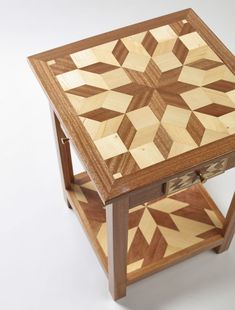 a wooden table with two drawers on each side and an intricate design on the top