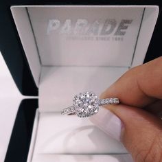 a woman's hand holding a diamond engagement ring in a box with the words, i love you on it