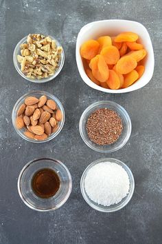 bowls filled with nuts, almonds, and other ingredients to make a healthy snack