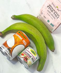 bananas, yogurt and other ingredients are on a counter next to a packet of protein