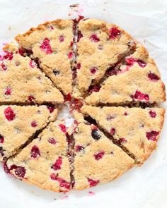 the pie has four slices cut out and is ready to be eaten with cranberry sauce on it