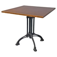 a square wooden table with metal legs