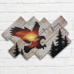 an eagle is flying in the sky with trees on it's back and sunset behind it