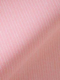 a close up view of a pink and white fabric with wavy lines on the side