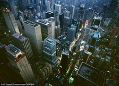 an aerial view of the city lights at night from high up in the skyscrapers