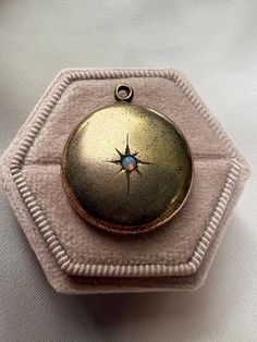 This vintage pendant is etched with a beautiful starburst with an opal at its center. It is not marked, but appears to be gold-filled. ERA - Circa 1950's METAL / MATERIAL - unknown metal CONDITION - Good; minor wear throughout with two small dents on back SIZE / MEASUREMENTS - 7/8 inch diameter *This is not a locket* Vintage Gold Star Jewelry, Antique Gold Opal Jewelry, Antique Opal Jewelry In Gold, Vintage Star-shaped Wedding Jewelry, Antique Gold Star-shaped Jewelry, Antique Yellow Gold Star Jewelry, Vintage Yellow Gold Opal Jewelry, Vintage Hallmarked Opal Jewelry, Vintage Opal Jewelry In Yellow Gold