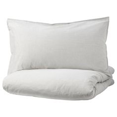 a white bed with two pillows on top of it and one pillow in the middle