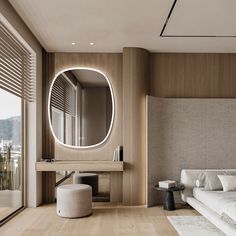 a bedroom with a large round mirror on the wall