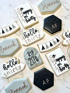 decorated cookies are arranged on a marble table