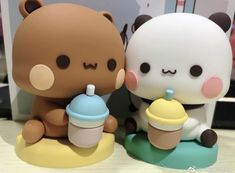 two cute little bears sitting next to each other