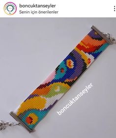 a key chain made out of beads with an image of flowers on the front and side