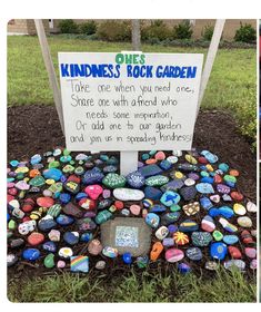 a rock garden with a sign that reads kindness rocks garden take one when you need one