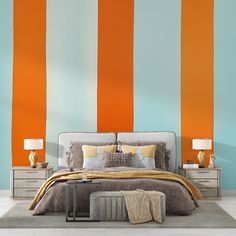 an orange and blue striped wall in a bedroom with a bed, nightstands and lamps