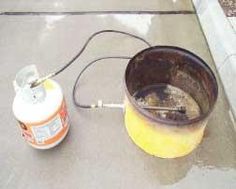 a yellow bucket sitting on top of a sidewalk next to a sprayer and a can