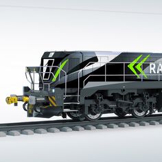 a black and green train engine on the tracks with its lights on, in front of a white background