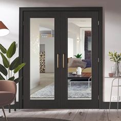 a living room filled with furniture and a large glass door that opens to the outside