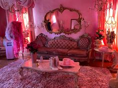 a fancy living room with pink walls and chandeliers on the windowsills