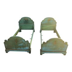 two green metal beds sitting side by side on top of each other in front of a white background