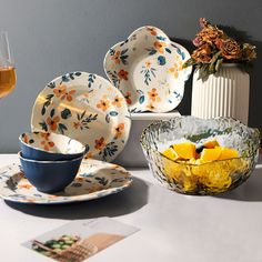 plates and bowls are arranged on a table