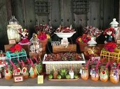 an assortment of candy and candies are displayed on a table in front of wooden doors